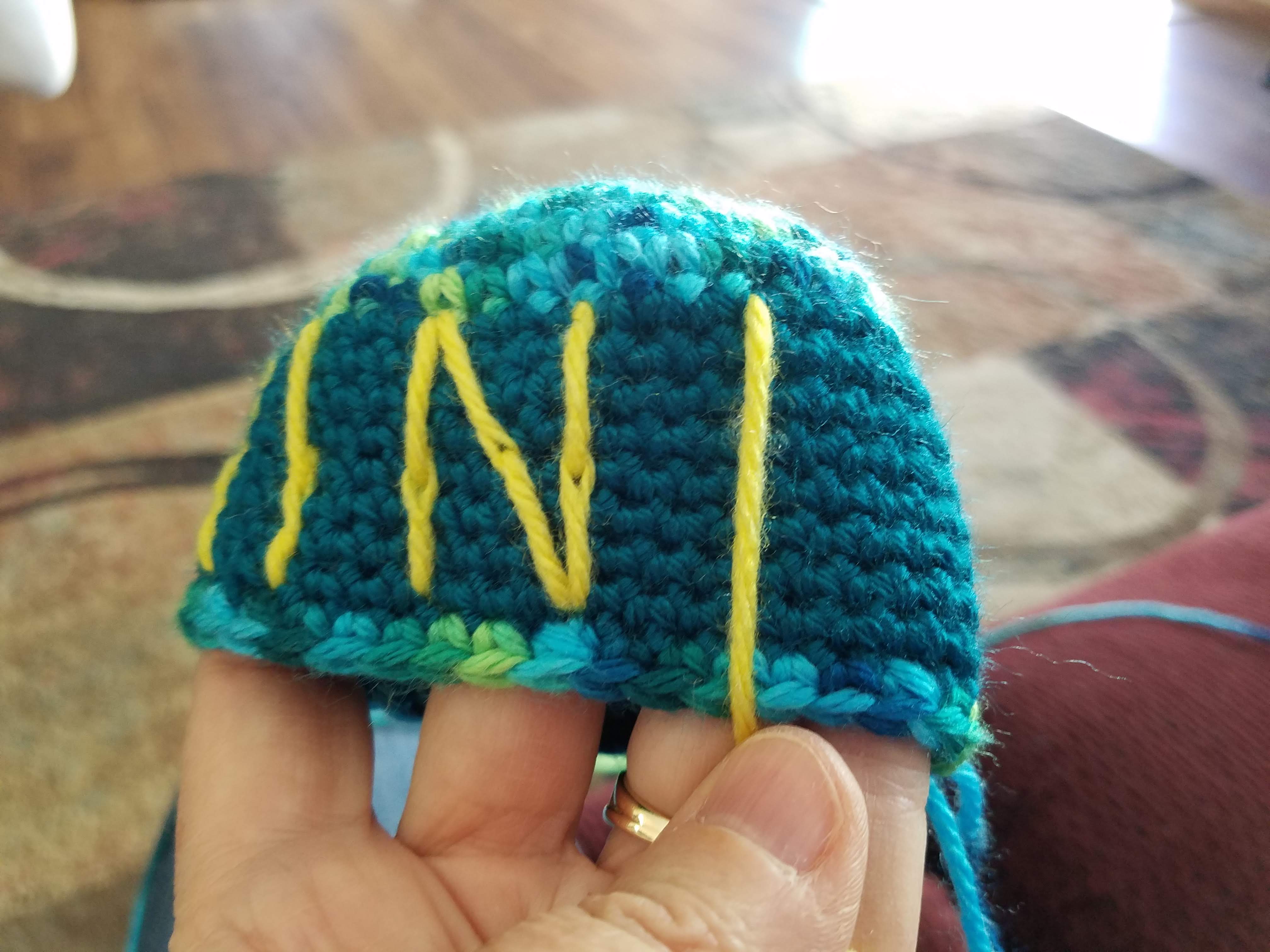 Use the yarn to help you create straight letters, by pulling it straight like a plumb line, before you start embroidering the letters.